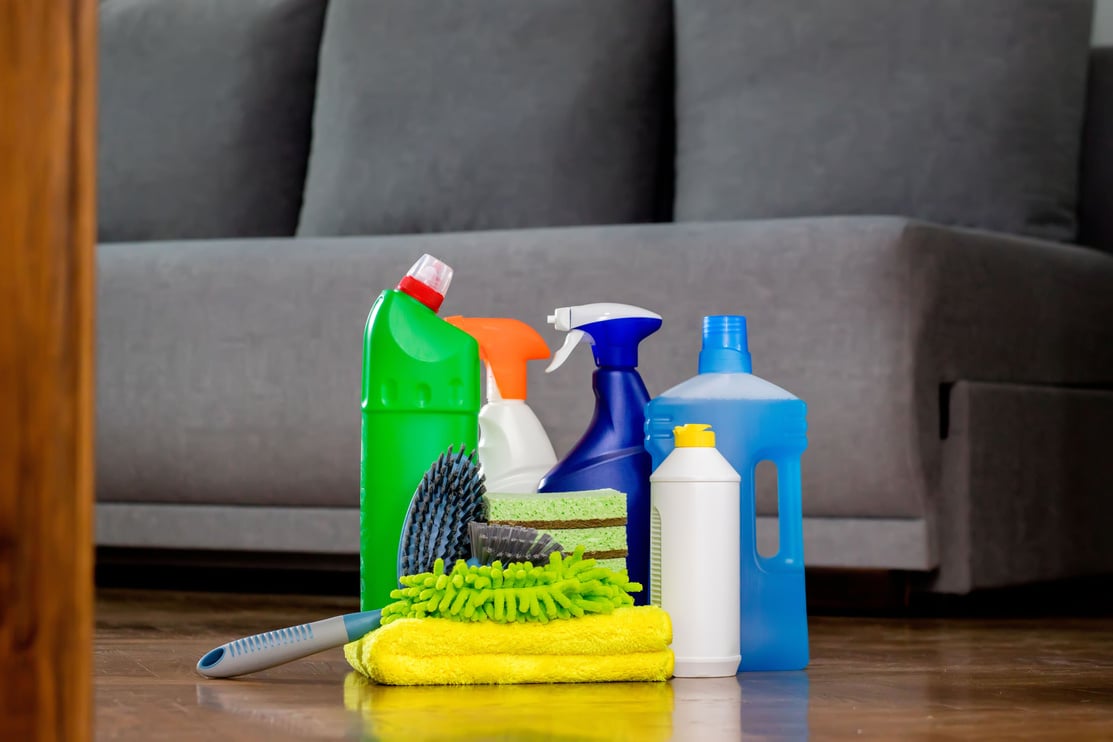 Household cleaning products and rags on floor. Chemical liquids for cleaning. Maintaining cleanliness